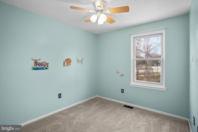 unfurnished room with visible vents, baseboards, and carpet