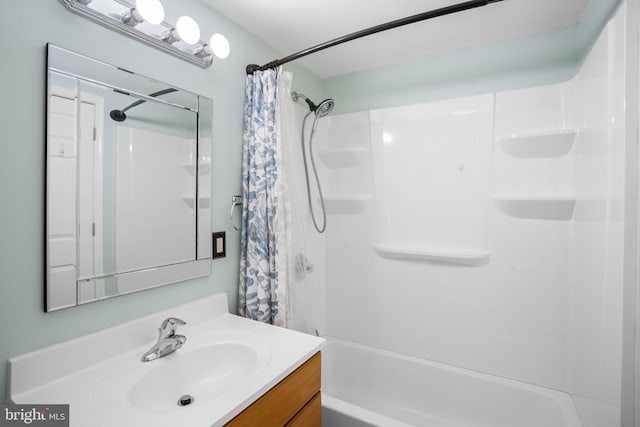 bathroom featuring shower / bathtub combination with curtain and vanity