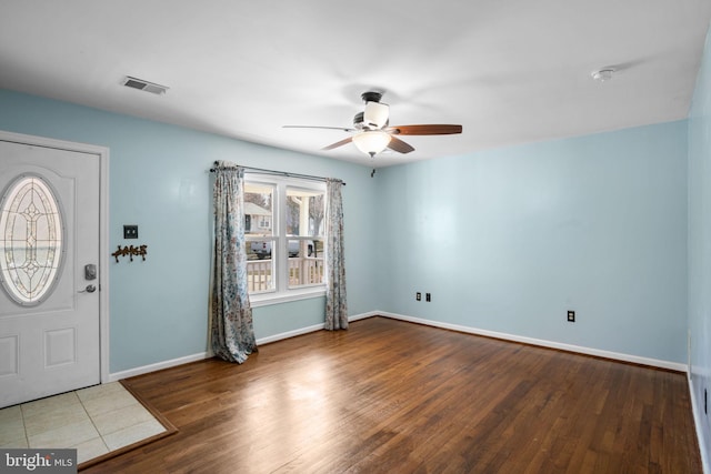 entrance foyer with visible vents, a ceiling fan, baseboards, and wood finished floors