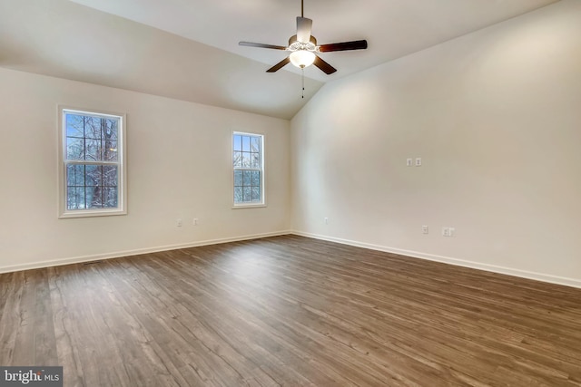 unfurnished room featuring baseboards, lofted ceiling, dark wood-type flooring, and a ceiling fan