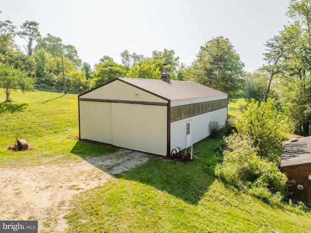 view of pole building with a yard and dirt driveway