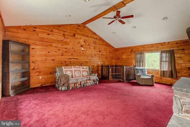 bedroom featuring carpet floors, vaulted ceiling with beams, wooden walls, and a ceiling fan