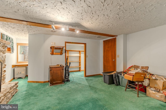 interior space featuring carpet floors, baseboards, and a textured ceiling