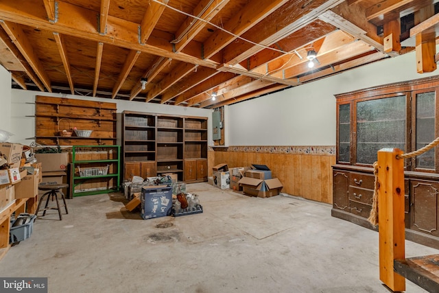 unfinished basement featuring wainscoting