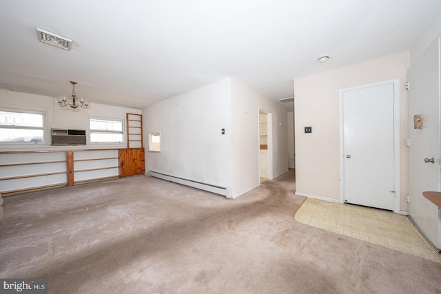 unfurnished living room featuring a chandelier, carpet flooring, visible vents, an AC wall unit, and baseboard heating