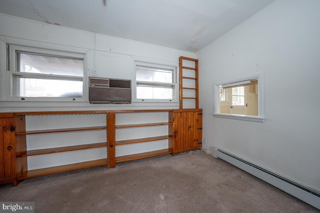 kitchen with a baseboard heating unit, light countertops, and light colored carpet