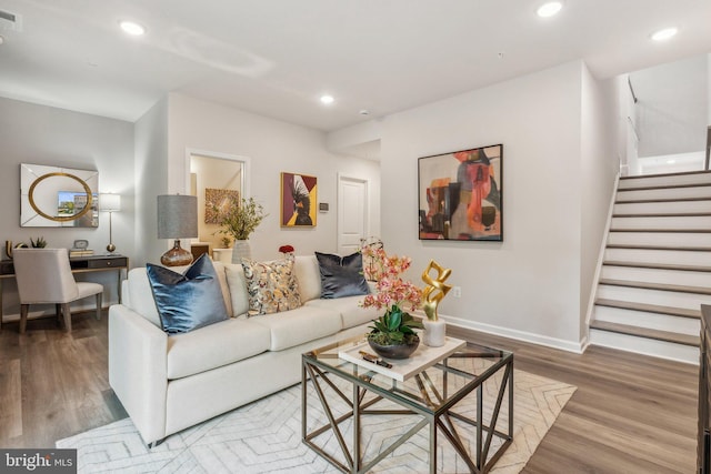 living area with stairs, baseboards, wood finished floors, and recessed lighting