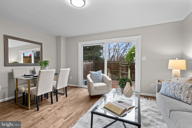 living room featuring baseboards and wood finished floors