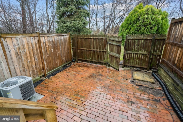 view of patio with a fenced backyard and central air condition unit