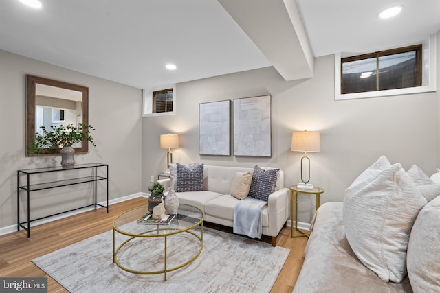 living room featuring baseboards, wood finished floors, and recessed lighting