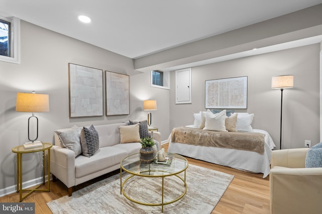 bedroom featuring baseboards, wood finished floors, and recessed lighting