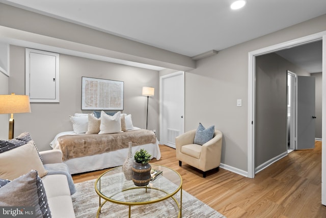 bedroom featuring baseboards, visible vents, and light wood-style floors