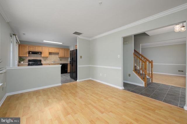 kitchen with visible vents, backsplash, wood finished floors, under cabinet range hood, and black appliances