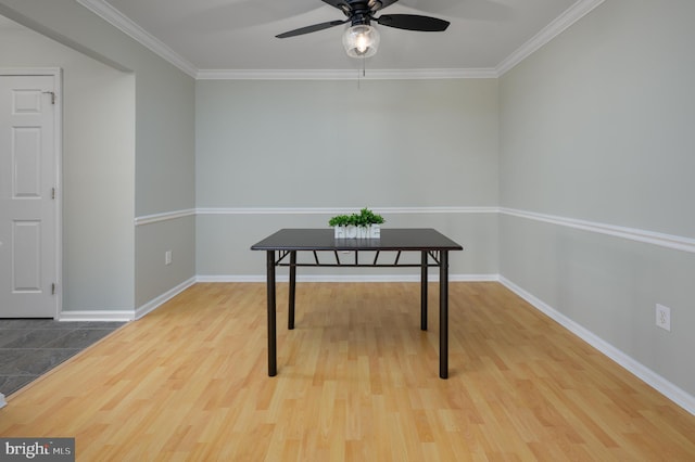 office featuring ornamental molding, ceiling fan, baseboards, and wood finished floors