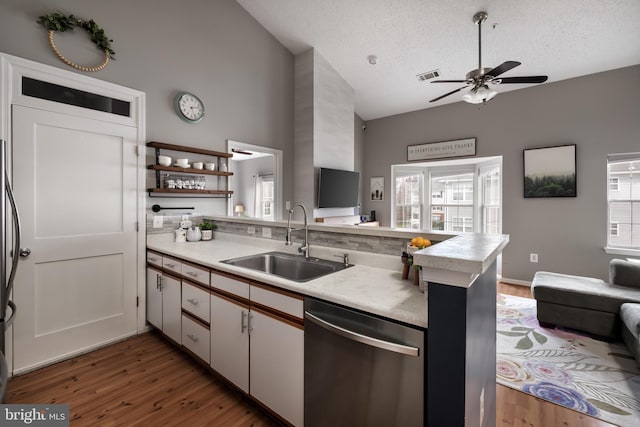 665 Constellation Sq SE Unit F, Leesburg, VA 20175 - kitchen with dishwasher, a sink, high vaulted ceiling, a peninsula, and light countertops