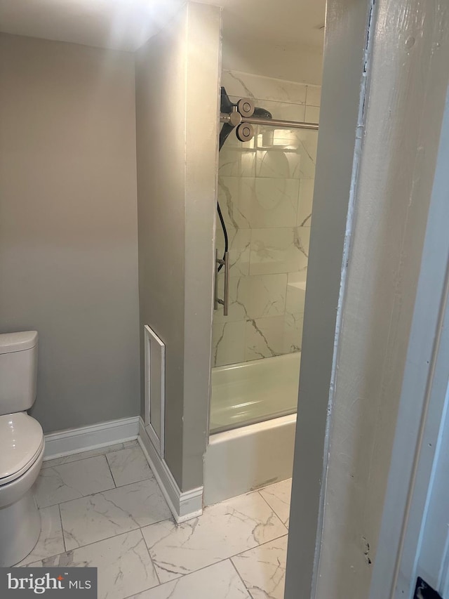 full bath featuring toilet, marble finish floor, baseboards, and walk in shower