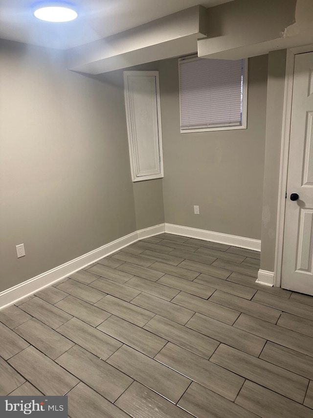 finished basement featuring wood finish floors and baseboards