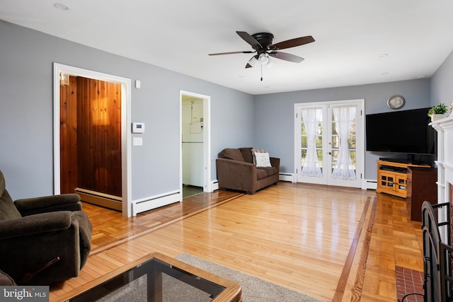 living area featuring parquet flooring, a baseboard radiator, a baseboard heating unit, and french doors