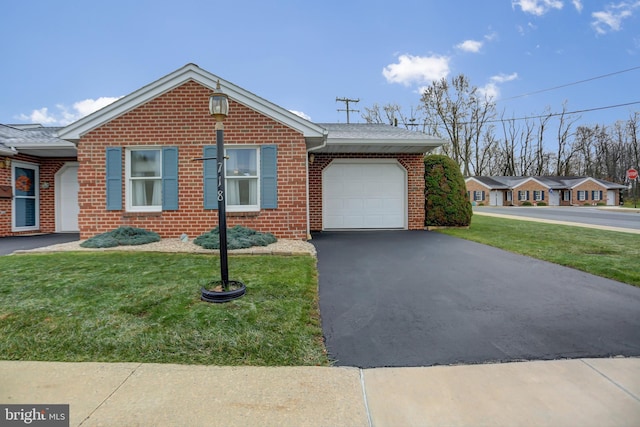 ranch-style home featuring a front lawn, aphalt driveway, an attached garage, a shingled roof, and brick siding