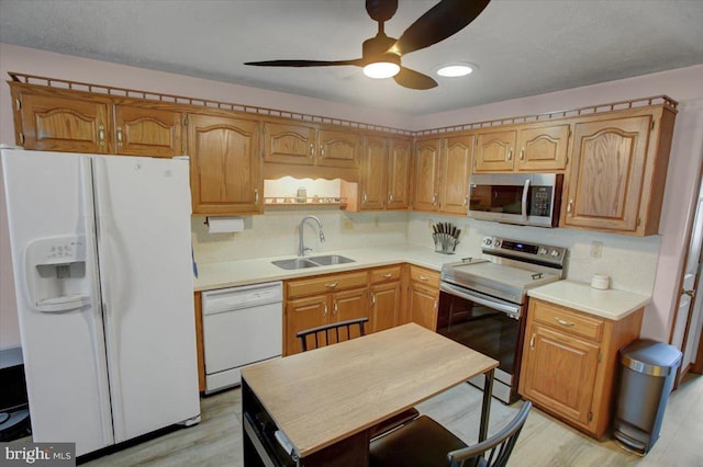 kitchen with light countertops, tasteful backsplash, appliances with stainless steel finishes, and a sink