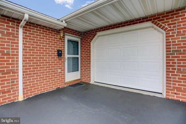 garage with aphalt driveway