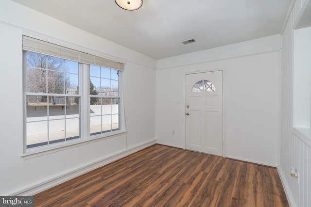 entryway with baseboards, visible vents, and dark wood-style flooring