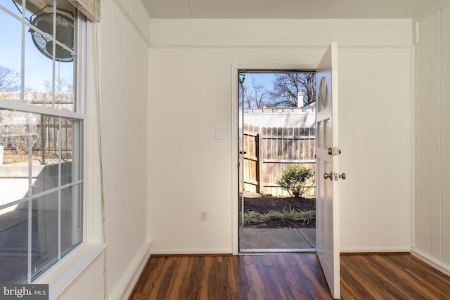 doorway to outside with baseboards and wood finished floors