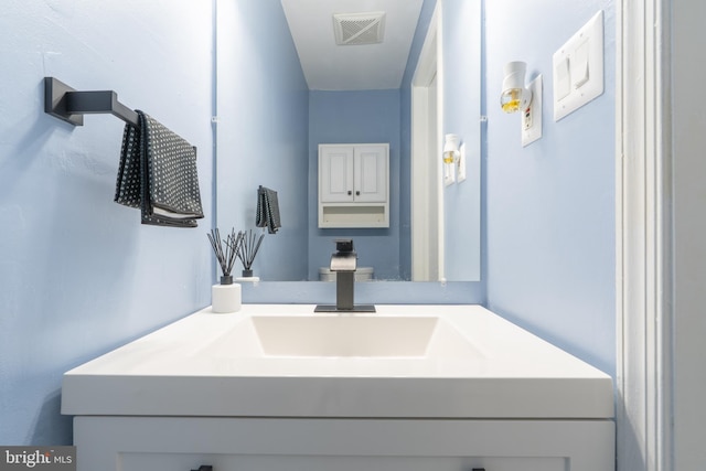 bathroom featuring vanity and visible vents