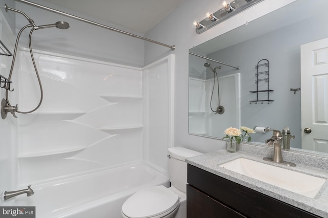 bathroom featuring shower / bathing tub combination, vanity, and toilet