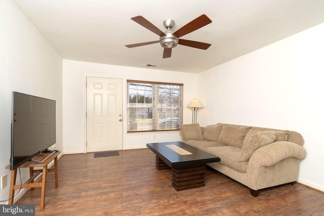 living area with a ceiling fan, dark wood-style flooring, visible vents, and baseboards