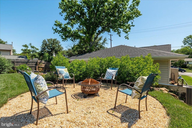 view of patio featuring an outdoor fire pit and fence