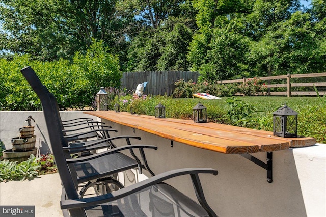 exterior space with fence and outdoor dry bar