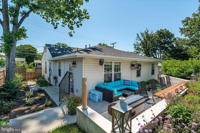 back of house featuring a patio area, fence, an outdoor living space, and roof with shingles