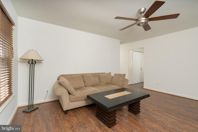 living area with a ceiling fan, visible vents, baseboards, and wood finished floors