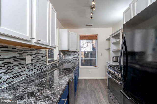 kitchen featuring blue cabinets, a sink, visible vents, white cabinets, and appliances with stainless steel finishes