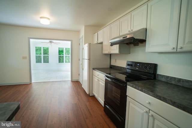 kitchen featuring electric range, dark countertops, dark wood finished floors, and under cabinet range hood