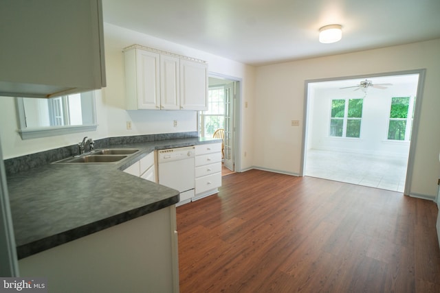 kitchen featuring white cabinets, dark wood finished floors, dishwasher, dark countertops, and a sink