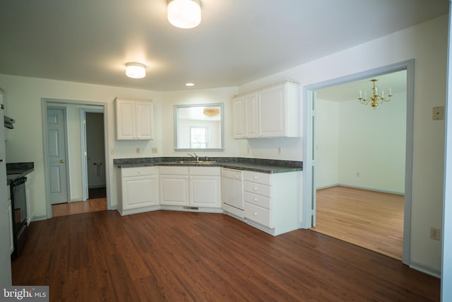 kitchen with dark countertops, dark wood-style floors, black range with electric stovetop, white dishwasher, and a sink