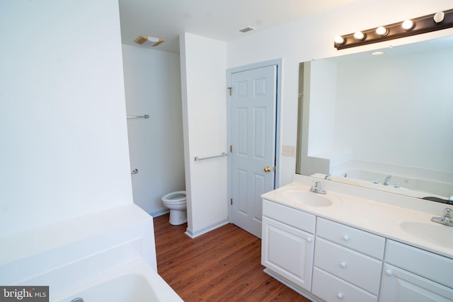 full bath with wood finished floors, a sink, and a bath