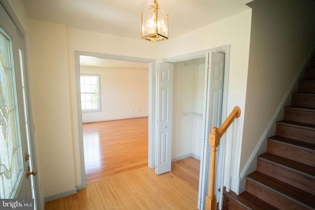 stairway featuring wood finished floors and baseboards