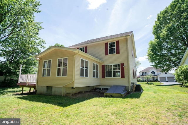 back of property with cooling unit, a lawn, and a deck