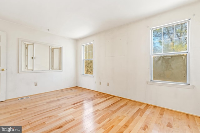 empty room with visible vents and wood finished floors