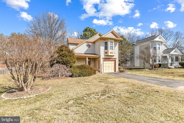 view of front of property featuring an attached garage, a front lawn, and aphalt driveway