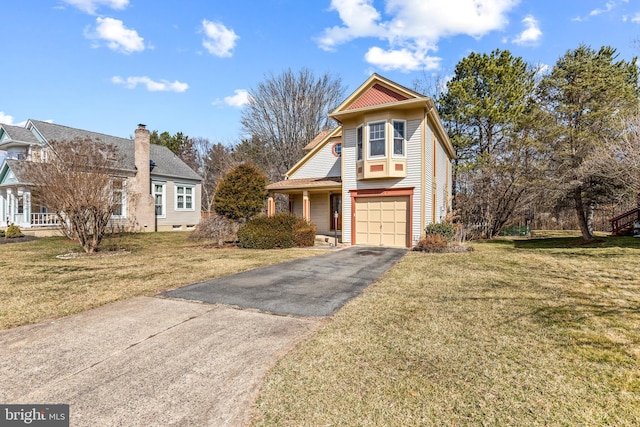 view of front of home featuring a garage, aphalt driveway, and a front yard