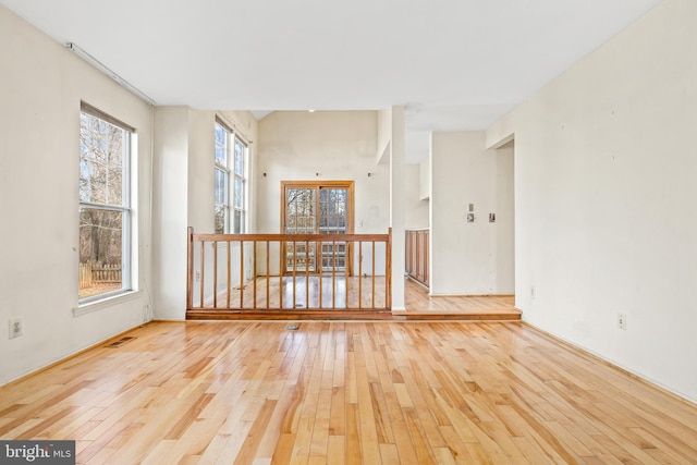 spare room featuring visible vents and hardwood / wood-style flooring