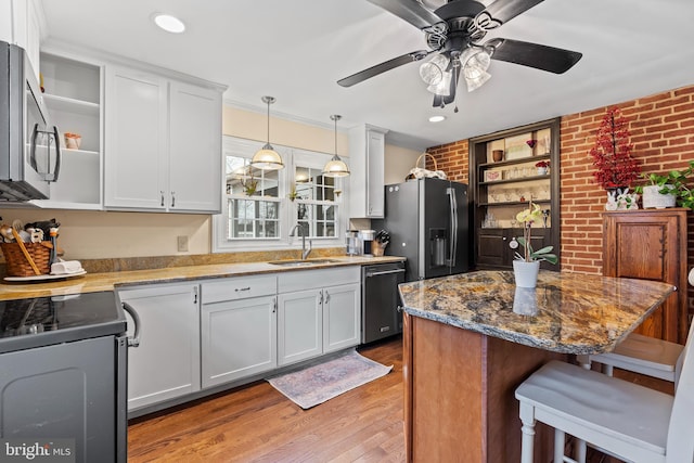 kitchen with dishwashing machine, refrigerator with ice dispenser, open shelves, and a sink