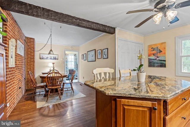 kitchen with brick wall, ornamental molding, brown cabinetry, and dark wood-type flooring