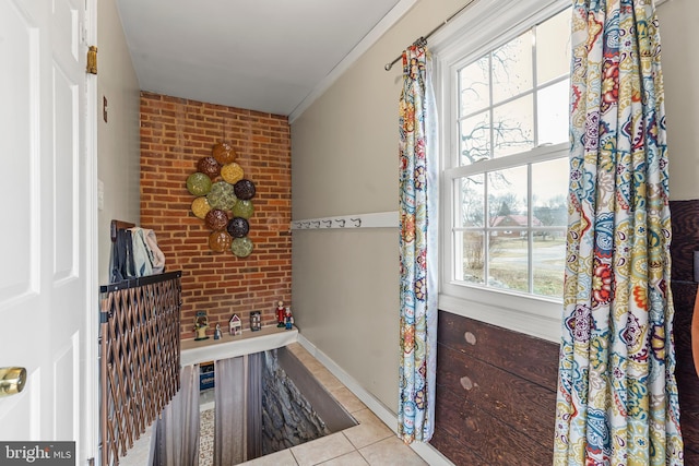 interior space with brick wall and ornamental molding