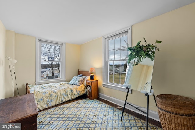 bedroom featuring baseboards and wood finished floors