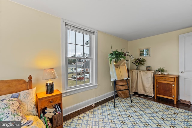 sitting room with baseboards and wood finished floors